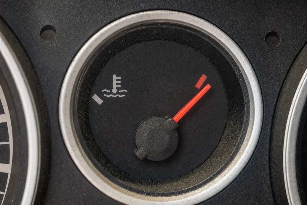 Car temperature gauge in red indicating overheating engine warning