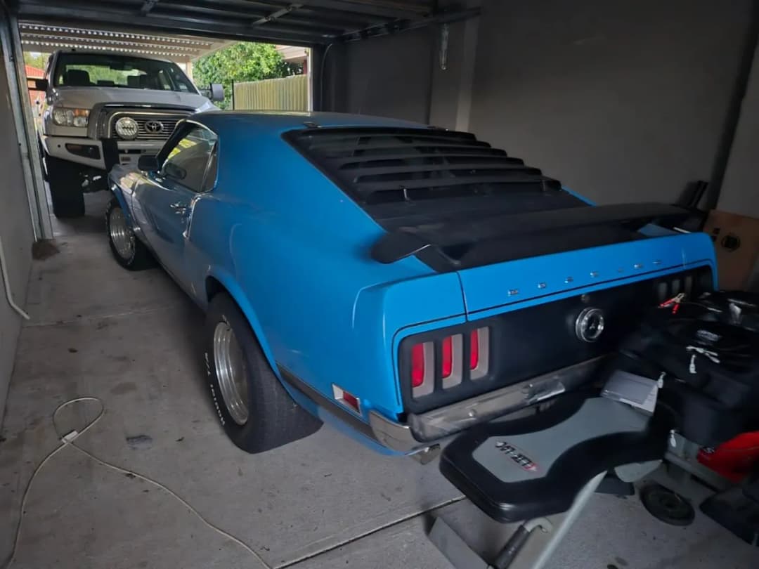 Blue classic Ford Mustang fastback in a home garage