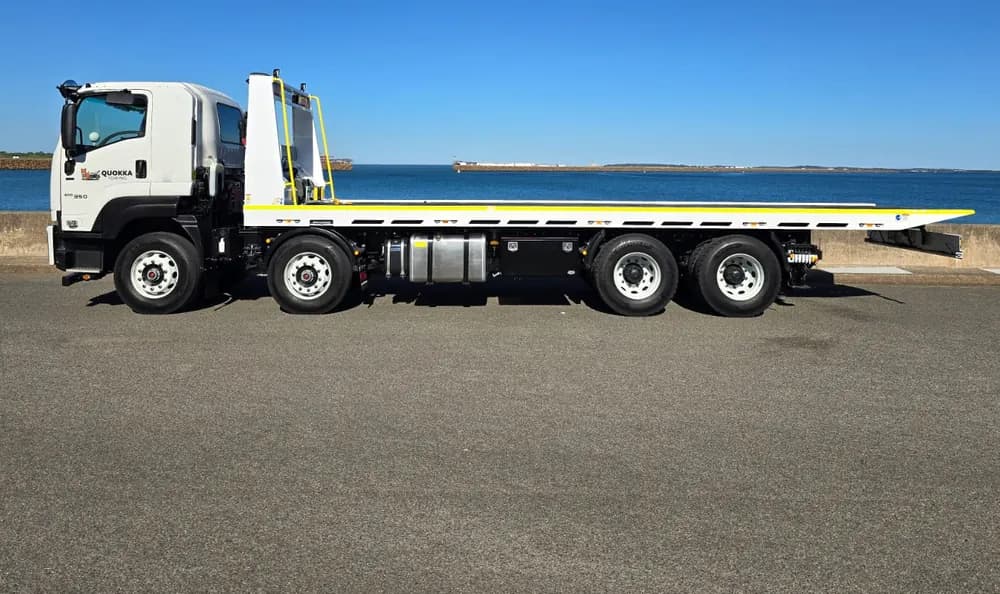 Quokka Towing eight-wheel tilt tray truck parked by the water