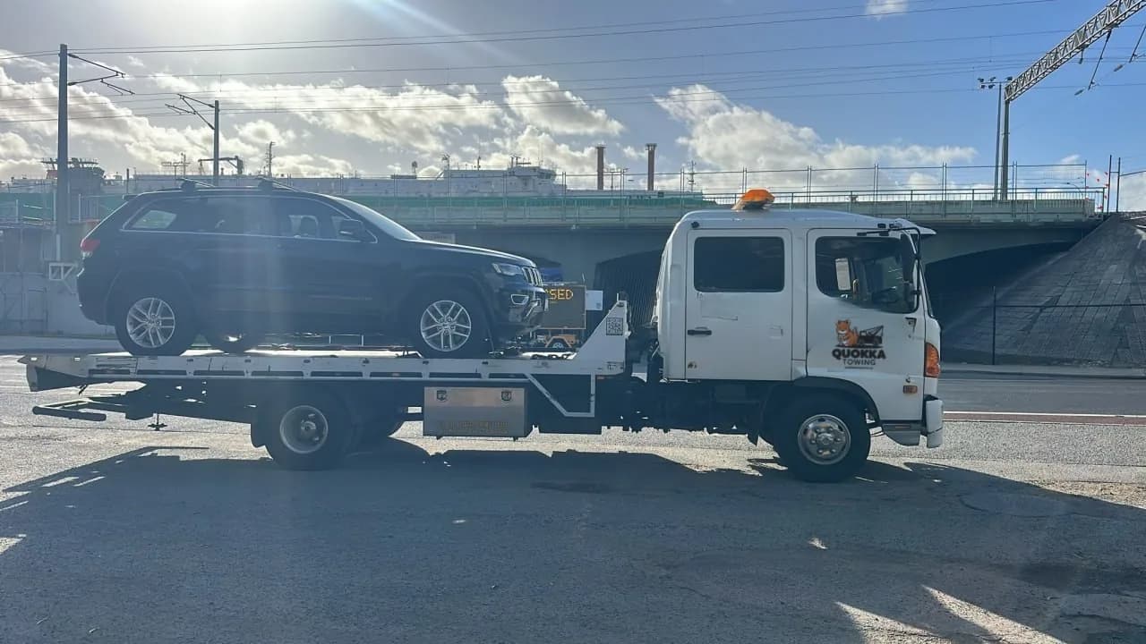 Quokka Towing tilt tray carrying a black SUV