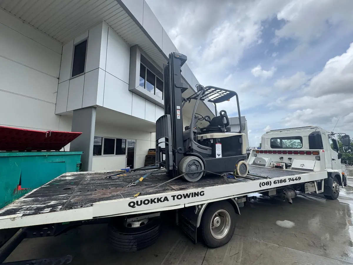 Electric forklift strapped down on a Quokka Towing tilt tray