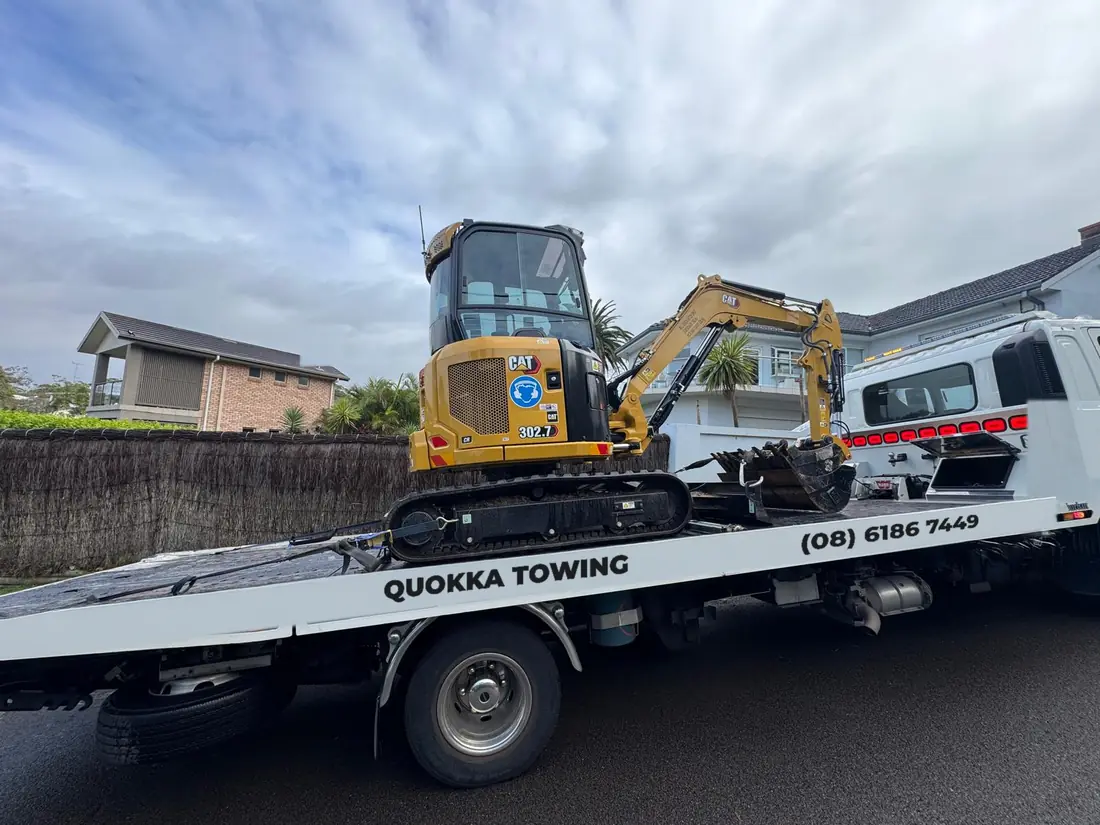 Mini excavator strapped down on a Quokka Towing tilt tray