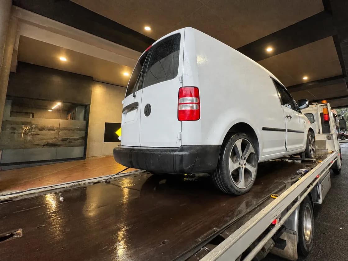 Quokka Towing tilt tray collecting a white van from a basement carpark entrance