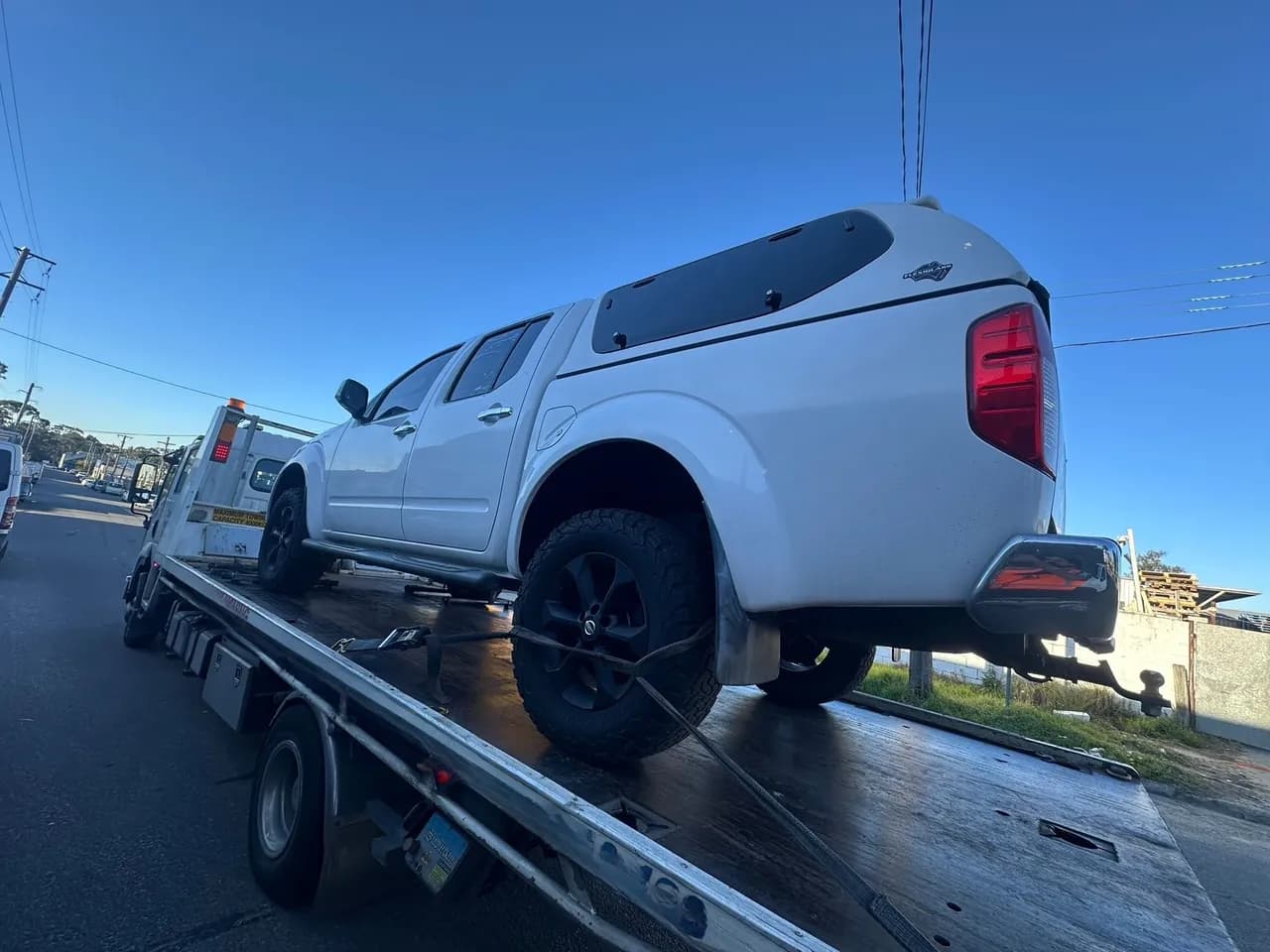 Quokka Towing tilt tray carrying a white dual-cab ute with a canopy