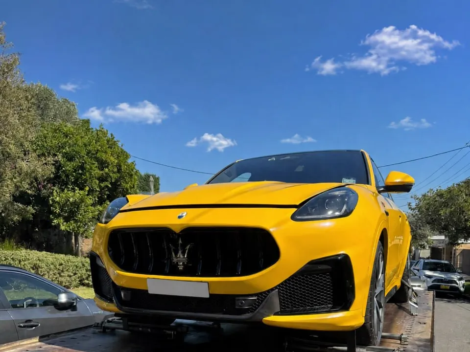 Yellow Maserati SUV loaded on a Quokka Towing tilt tray