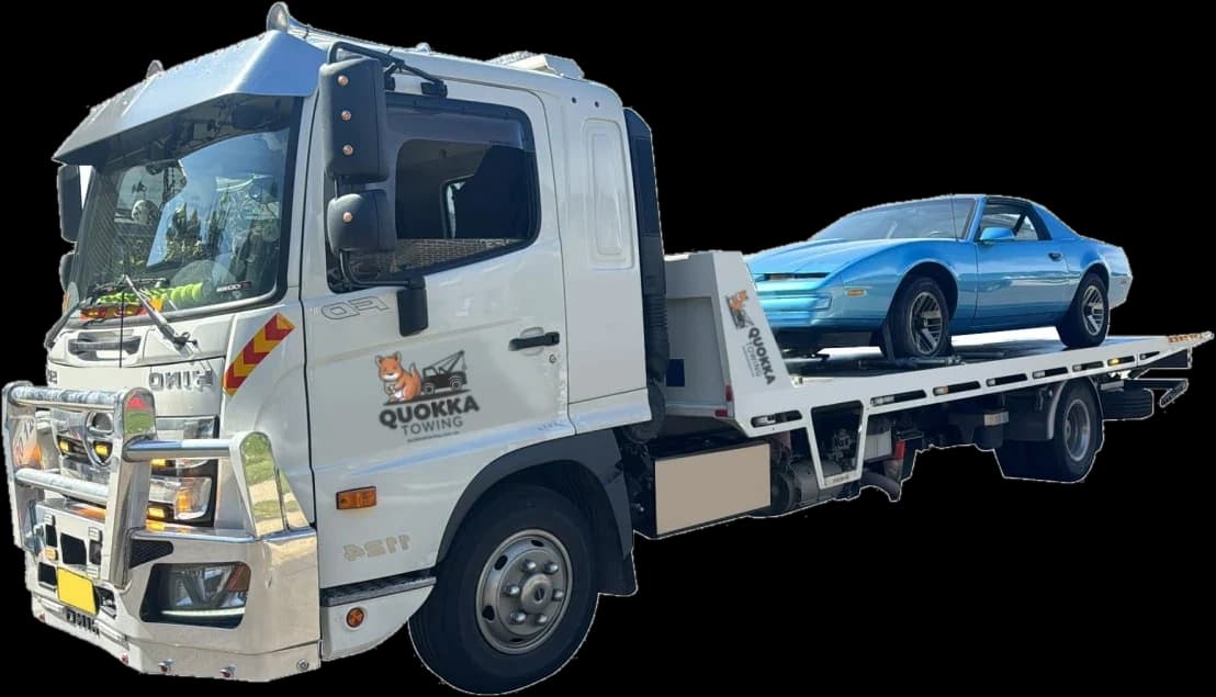 A Quokka Towing tilt tray carrying a blue classic coupe
