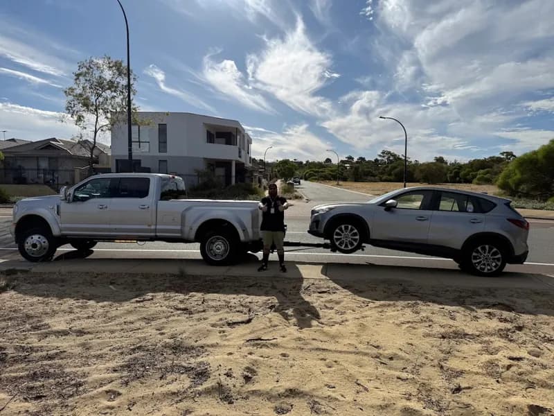 Quokka Towing F-450 wheel-lift towing a grey SUV on a suburban road