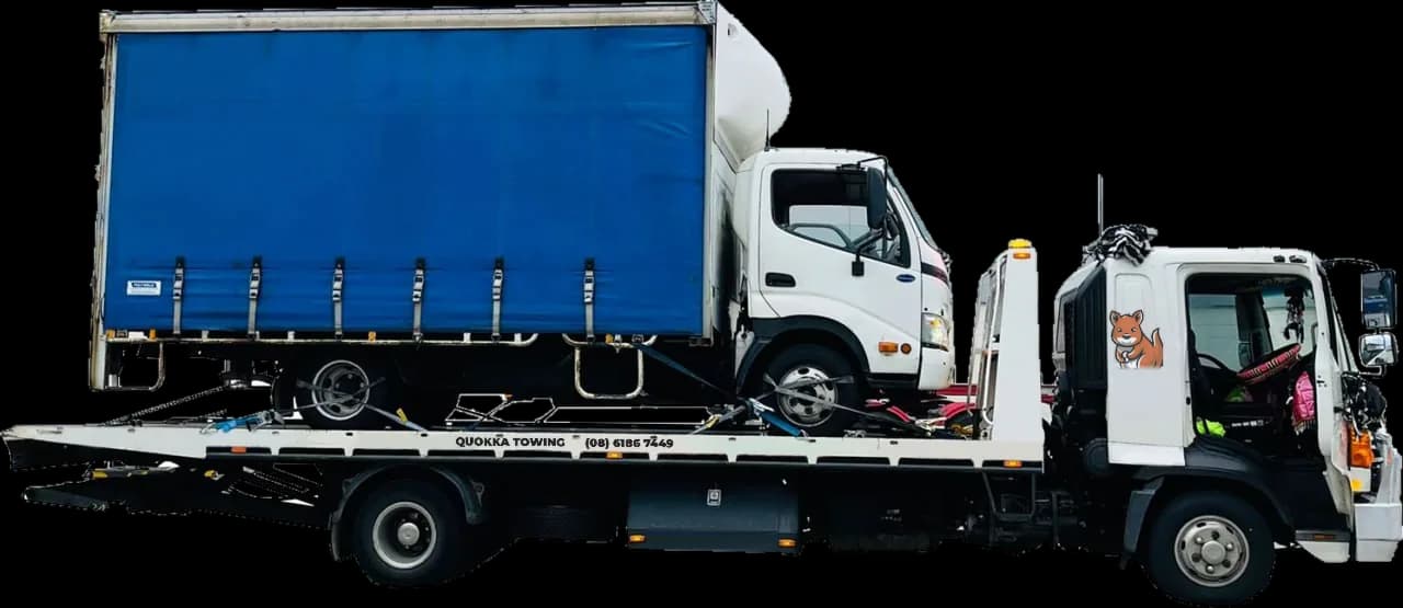 Blue curtain-sider truck strapped down on a Quokka Towing tilt tray